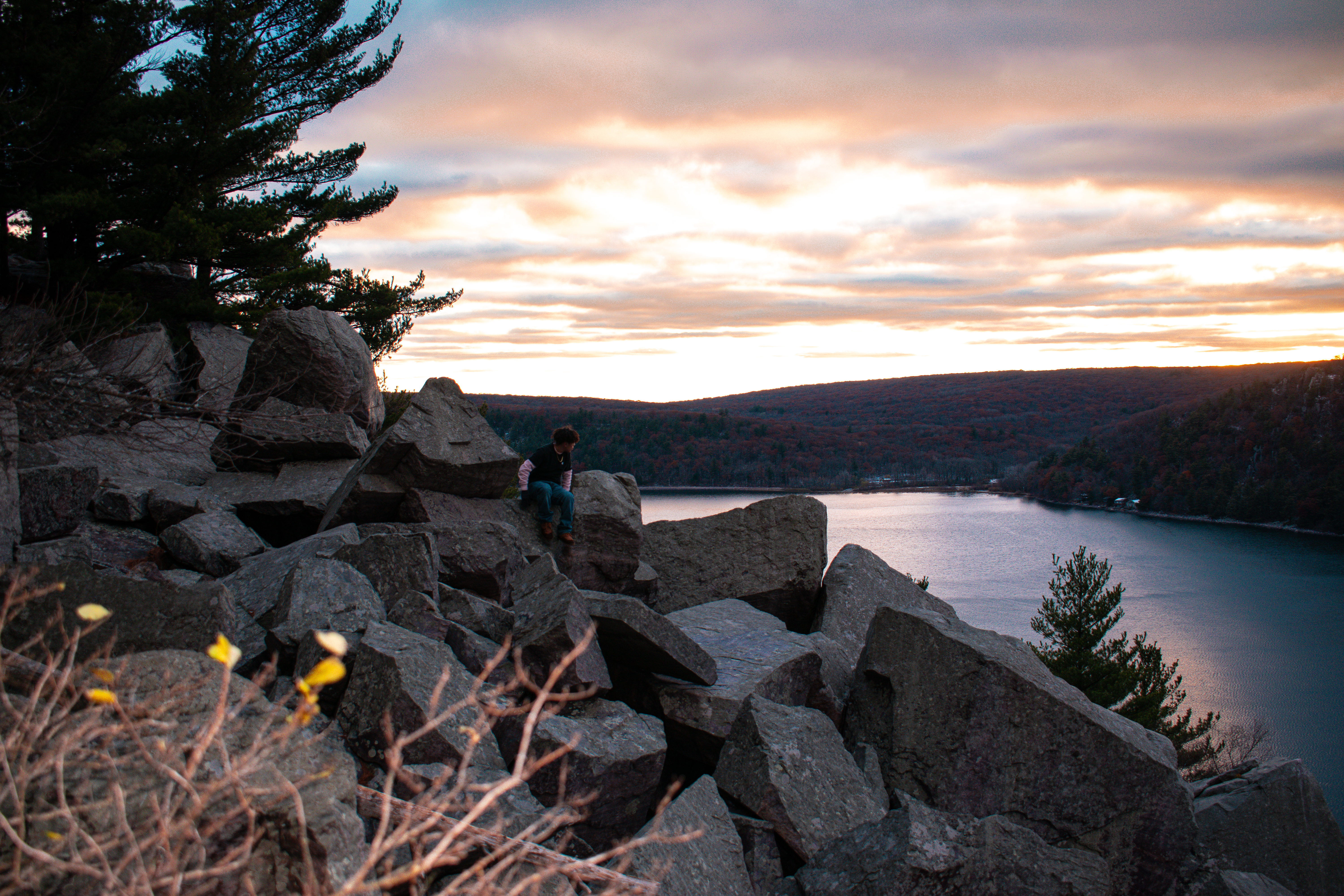 Person on rocks at Devils Lake looking away from camera